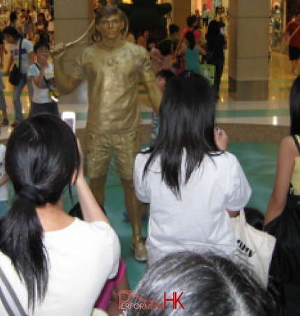 Living statue tennis player performing in the mall