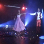 Magician and his stunning assistant stepping on stage for an illusion show.