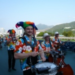 Four HK musician walking around at a corporate function.