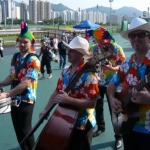 Four roving magicians playing drums guitar cello entertaining crowds at the Hong Kong racecourse