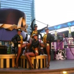 4 dancers in front of giant hat prop at a mall in Hong Kong
