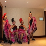 Four Can Can dancers in their pink and black dresses looking confident for their performance at HKCEC.