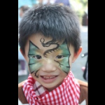 Celebrating chinese new year with a dragon design face paint.