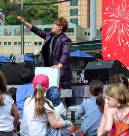 Kids watching magic man with purple suit