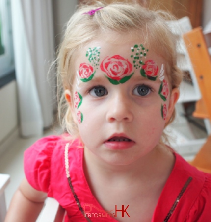 Hong Kong face painter paint a lovely rose crown face paint for a little girl at a children birthday party