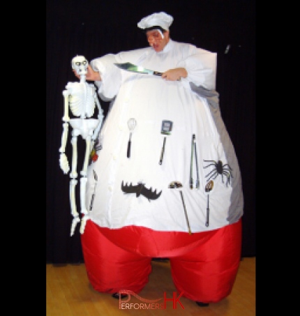 Hong Kong stiltwalker wearing inflatable chef costume pointing a knife to a skull at a Halloween corporate event