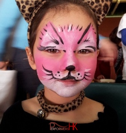 A face painter form HK drew a pink kitten face paint for a girl at a animal themed party.