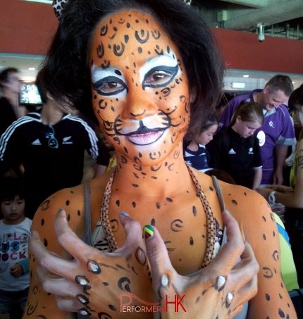 A Hong Kong talented face painter draw a half body leopard paint for a lady at a corporate function.