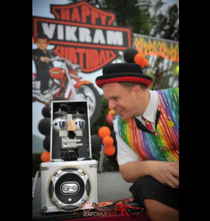 Andy Comic magician looking at mini robot