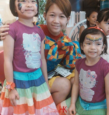 2 little girls in Hong Kong with butterfly face paint.