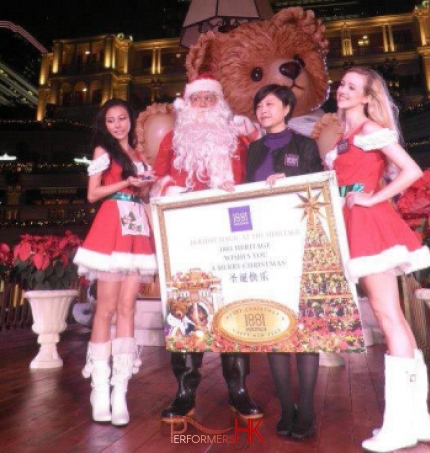 Two Santa girl and Santa award to a lady at a Corporate Christmas event