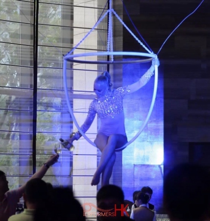 Hong Kong Aerial Champagne performer serving Champagne to the guests on a huge ring at a corporate cocktails event