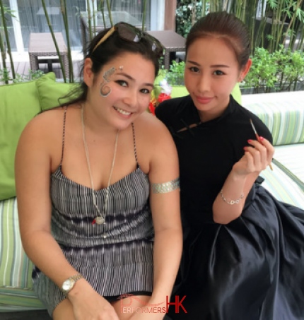 Face painter in Hong Kong taking picture with her client after she finished a beautiful face painting at a event