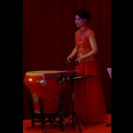 Chinese music musician in Hong Kong playing traditional instrument Bamboo Castanets behind the Chinese drum on the stage