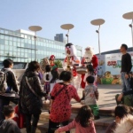 Three piece music trio on stage at Cyberport in Hong Kong wearing santa snowman and elf outfits
