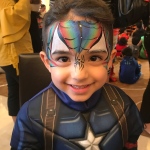 Spiderman face paint on Capt American kid