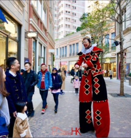 performance on the streets in stilt costume interacting with guests