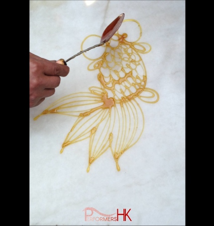 marble surface with goldfish Sugar painting (糖画) on at an event 