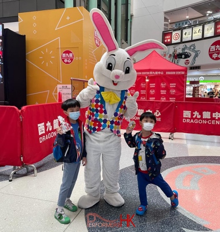 easter bunny mascot character taking photo with 2 kids