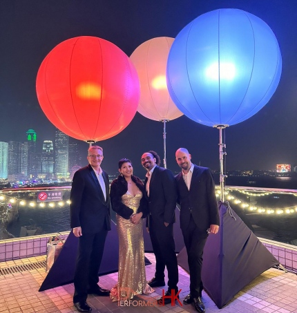 band at the hk jewlery fair provided by performers hk standing in front of 3 illuminated balloons