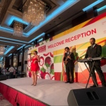 recently mentioned event by financial sec. of Hong Kong; Asia fruit logistica with singer and 2 musician on stage in black suit and red dress respectively