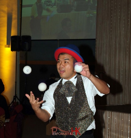 Clown in Hong Kong juggling 3 balls at a corporate event