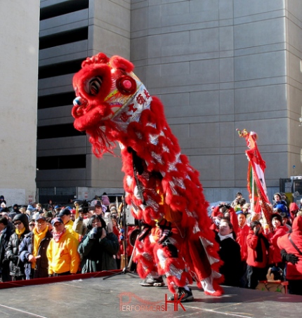 Hong Kong Dancer performing Lion Dance with the Red Lion on the street for a Chinese new year corporate event