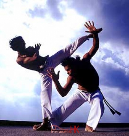 Two male doing Brazilian martial arts