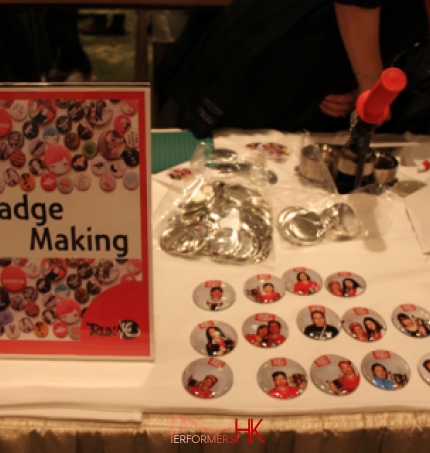 table with a bunch of badges at an event