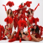 Vegas showgirls costume with bright red feathers and extravagant head gear.
