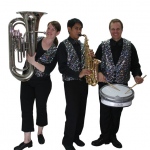 a three piece roving band in sparkle vests 