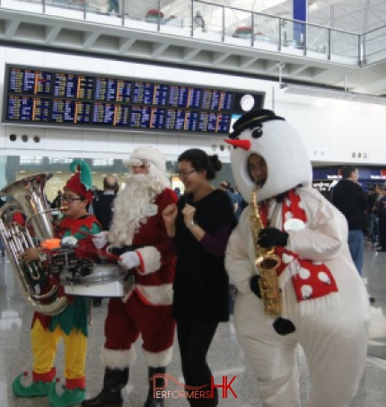 Roving three piece band with tuba sax and drum at HKIA