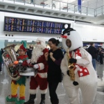 Roving three piece band with tuba sax and drum at HKIA