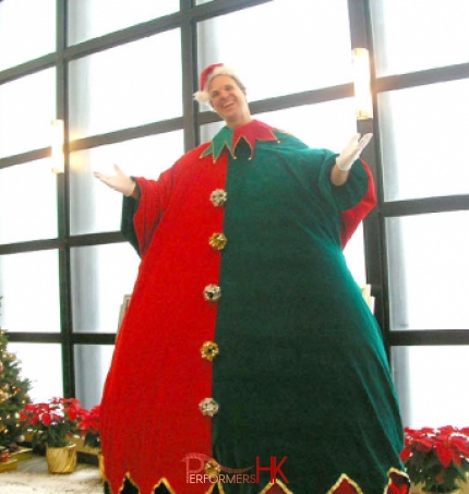 fat brothers giant stilt walker in elf costume in front of xmas tree in repulse bay zoomed in image