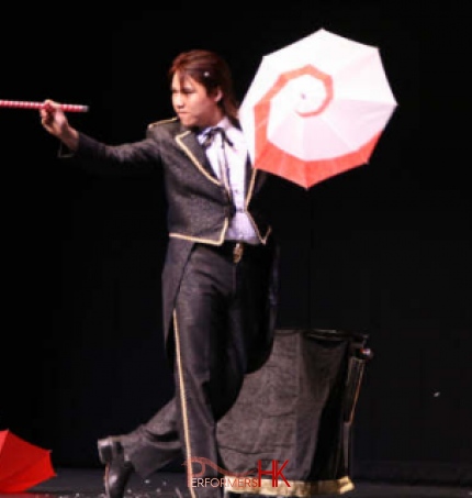 Hong Kong magician performing stage illusion magic with umbrella and wand at corporate annual dinner 