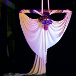 Performers show their skills by manipulating silk clothes in midair. 