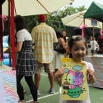 A little girl showing off her sand art work at a Hong Kong school event