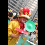 Roving juggling clown in Hong Kong posting with two juggling plates at a corporate family day