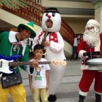 Three strolling magicians playing at Repulse Bay dressed as an elf, snowman and santa