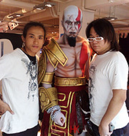 Hong Kong face painter taking picture with his fabulous work at a corporate event.