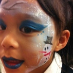 Face painter in Hong Kong paint a Xmas themed face paint for a little girl at Christmas corporate event