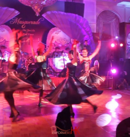 four cancan dancers spinning in circle on dance floor at an event
