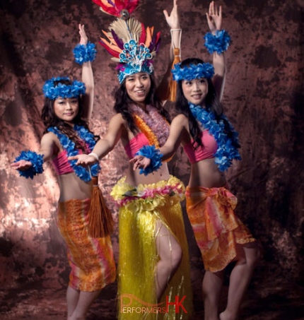 3 island dancers posing in costumes for photoshoot