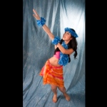 Hula dancer dressed in bright, beautiful skirts and leis. 