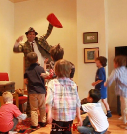 Hong Kong juggler holding a red bag going to give out candies to the kids at the birthday party 