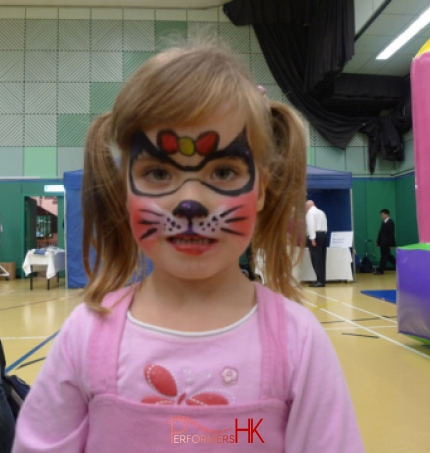 A little girl in HK got her face paint as a kitten by a face painter at a Hong Kong
corporate function in HKFC.  