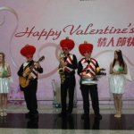 Roving three piece band with drum sax and guitar walking around Hong Kong airport wearing valentine day costumes