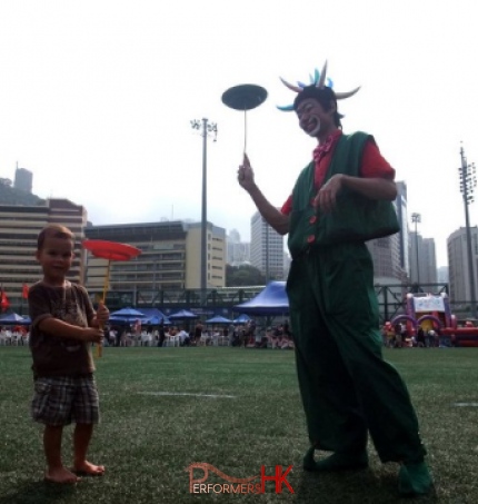 Hong Kong roving clown juggler spinning a circus plate with a guest at a corporate event in HK Football Club