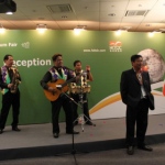 A guest taking picture with the live band musician at a Hong Kong networking reception event