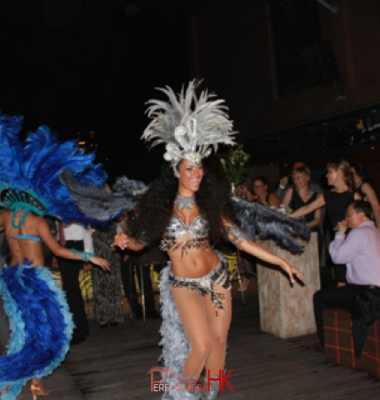 Two brazilian dancers dancing to business guest and a corporate staff party